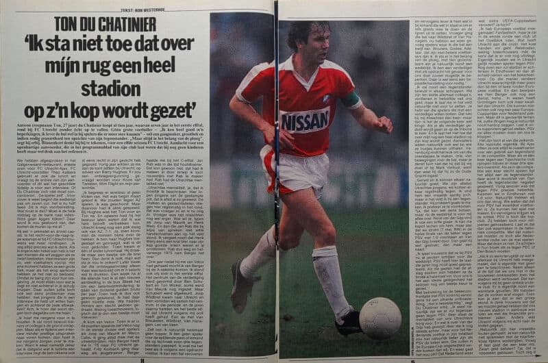 Voetballer in actie tijdens een wedstrijd, met een voetbal en sportkleding, op een grasveld.