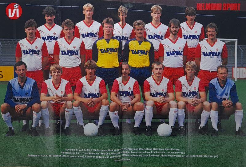 Voetbalteam in wedstrijdoutfits met teamleden en coaches.